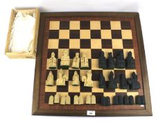 A marquetry chess board and a Lewis style chess set.
