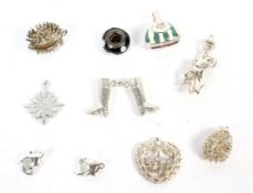 A collection of ten silver and white metal charms. Including boots, handbag and hedgehogs.