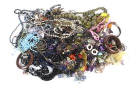 An assortment of costume jewellery. Including necklaces, bracelets, brooches, etc.