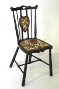 An early 20th century sweetheart bedroom chair.