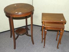 A Georgian style nest of two side tables and a circular table with a shelf.