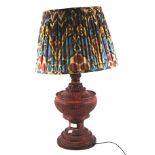 A large red cinnabar lacquered table lamp.