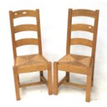 A pair of contemporary pine chairs.