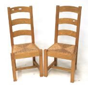 A pair of contemporary pine chairs.