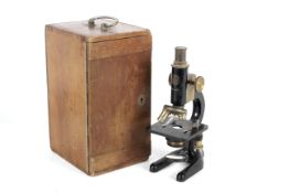 A mid-20th century C Baker London 9883 compound monocular microscope.