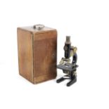 A mid-20th century C Baker London 9883 compound monocular microscope.