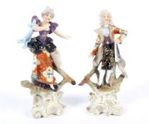 A pair of Continental porcelain figures of a gentleman and companion, circa 1900.
