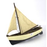 A vintage wooden model pond sailboat.