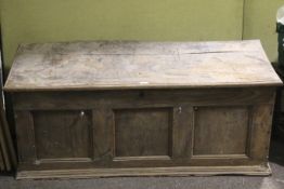 A 19th century oak panelled coffer. A two plank top with rounded edge.