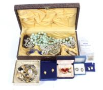 An assortment of costume jewellery. Including brooches, necklaces, pearl earrings, etc.