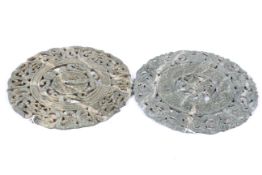 Two Chinese carved mottled green and white hardstone discs.
