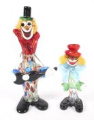 Two Murano glass clowns.