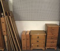 A contemporary pine triple wardrobe, a chest of drawers, and bedside cabinet.