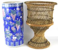 A 20th century ceramic umbrella stand and a wicker stand/plant holder.