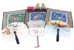 An assortment of Chinese collectables. Including fans, silks, a pair of temple dogs, etc.
