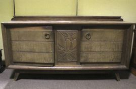 A heavy continental oak carved sideboard of large proportion.