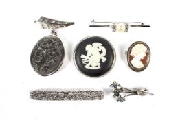 Six ladies silver and white metal brooches.