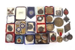 Collection of mid-20th century base metal medallions and badges awarded for marathons and walking