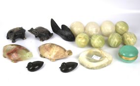 A collection of eight assorted stone eggs and some stone carved animals.