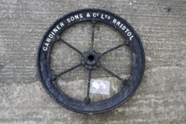 A vintage 'Gardiner Sons & Co. Ltd Bristol' cast iron pulley wheel.