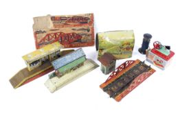 An assortment of O gauge tinplate train accessories.