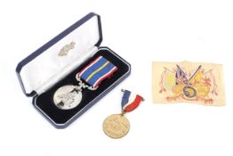 A boxed National Service Medal and an Ed