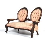 A Victorian carved mahogany two-seat par