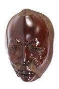 A large carved walnut tribal mask. Desig