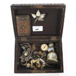 A carved wooden box with an assortment of costume jewellery.