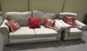 A cotton upholstered three piece suite with cushions.