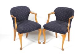 A pair of early to mid-20th century upholstered armchairs.