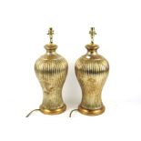 A pair of contemporary gilt finish table lamps.