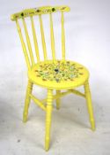 Wooden painted chair. Yellow with floral design on seat, on turned legs, H82cm.