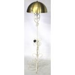 A metal standard lamp. Complete with golden dome shaped shade, H143cm.