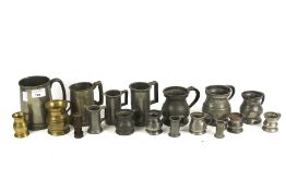 A collection of assorted vintage pewter tankards and measures.