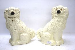 A pair of 19th century seated Staffordshire spaniels