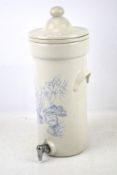 A water purifier. Of ceramic construction white with blue floral detailing, H47cm.