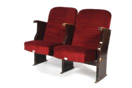 A pair of vintage conjoined cinema seats.