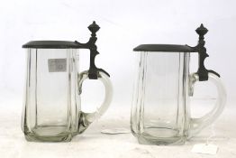 A pair of glass tankards with pewter mounts. H16cm.