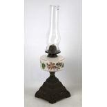 Victorian oil lamp. On brass base with floral design and glass shade, H52cm.
