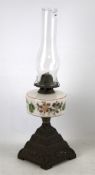 Victorian oil lamp. On brass base with floral design and glass shade, H52cm.