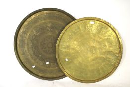 Two Islamic brass trays with floral detailing. Largest Diam 73cm.