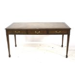An Edwardian oak writing table with inset leather top.