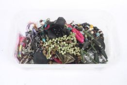 A large quantity of costume jewellery necklaces and bracelets in a box