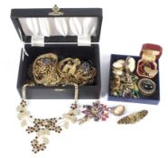 Two boxes of assorted costume jewellery. Including brooches, cuff links, bracelets, necklaces, etc.