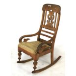 A Victorian walnut hard seat rocking chair.