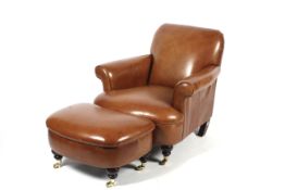 A Laura Ashley brown leather club-style armchair and foot stool.