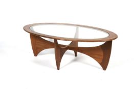 A 1960s G-Plan glass topped teak oval-shaped sofa table. On intersecting curved teak supports, L121.