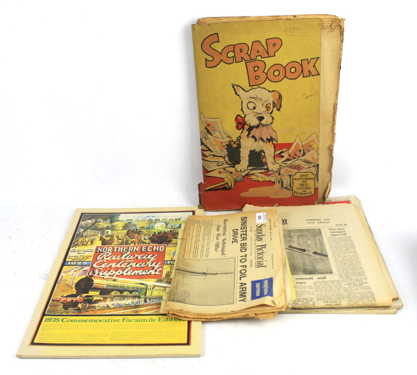 A railwayana related scrap book and a quantity of 1930s and later newspapers.