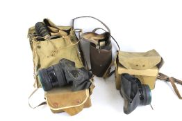 Four assorted WWII gas masks. With a military No 4 mk III B7'41 in original canvas bag, etc.